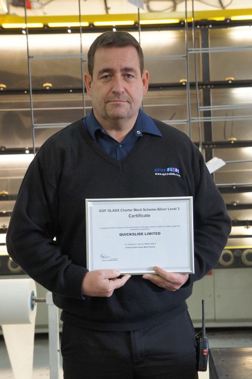 Quickslide’s Michael Connor proudly displays the GGF GLASS Charter Merit Scheme certificate