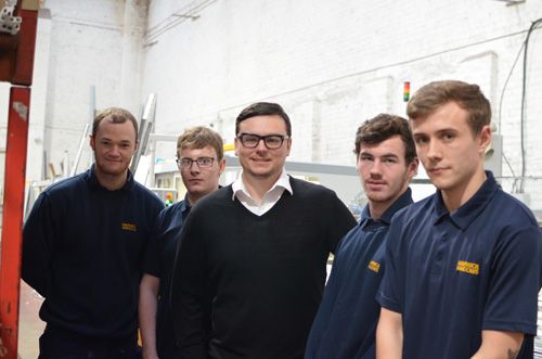 Director Greg Johnson (centre) with the apprentices
