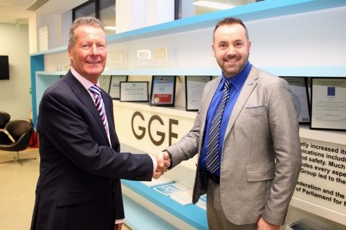 Outgoing President, Brian Baker (left), welcomes Andrew Glover as the new GGF President