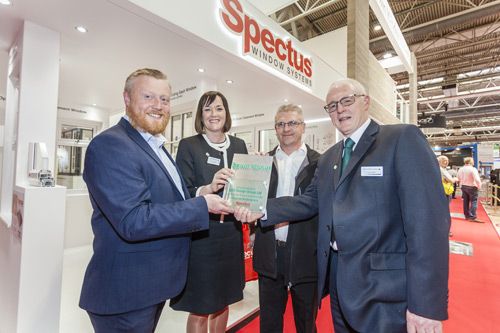 UCS’s managing director, Mark Scullion, is presented with an award to mark 10 years partnership with Spectus at the FIT Show by Epwin Windows Systems’ managing director, Clare O’Hara and sales director, Paul Lindsay