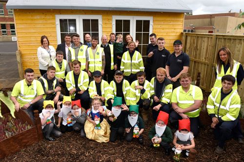 Pupils of Crosshouse Primary School join the team involved in the construction of the new ‘Happy Hive’, which will provide a calming sanctuary for young people with communications disorders and Autism.